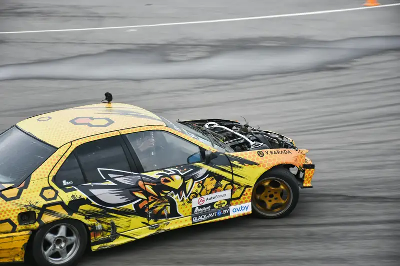 Yellow liveried drift car sliding on track