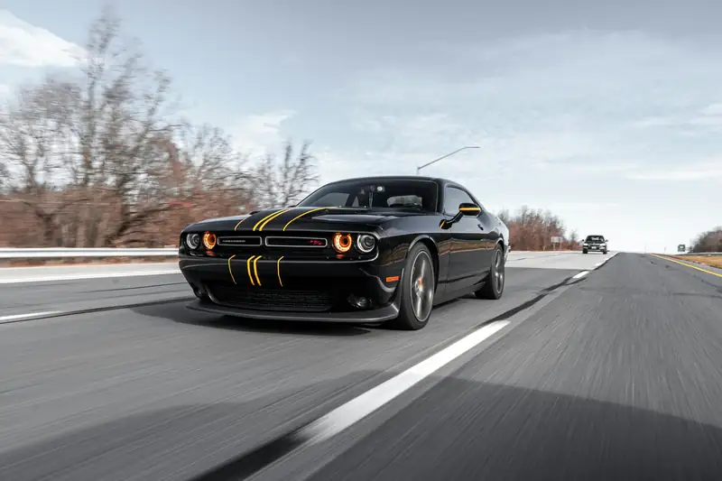 Black muscle car on an open road