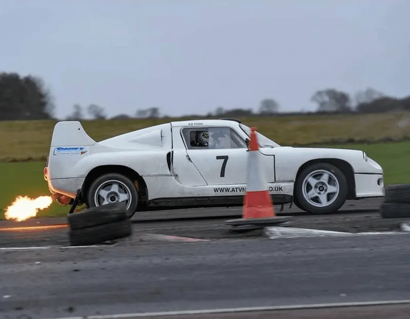 White sports car competing at an autotest