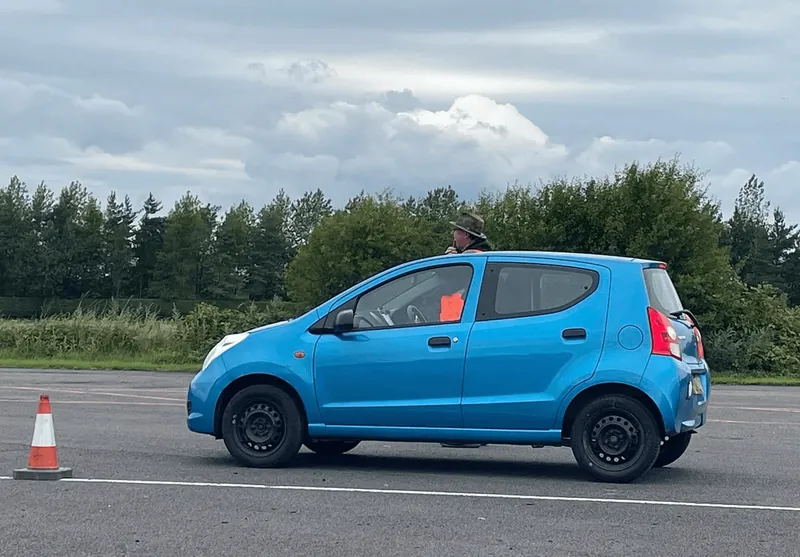 Blue hatchback competing at an autotest
