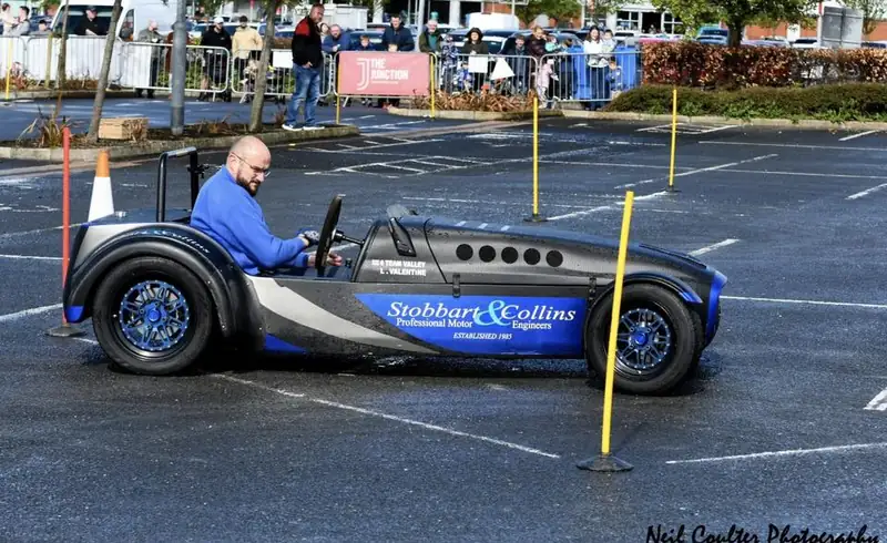 Lightweight sports car weaving between cones at an autotest